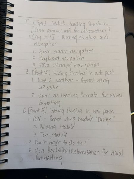 Handwritten notes in a notebook about website heading structure and navigation.