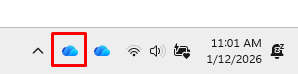 Screenshot of the righthand side of the Windows task bar with the OneDrive blue cloud icon highlighted.